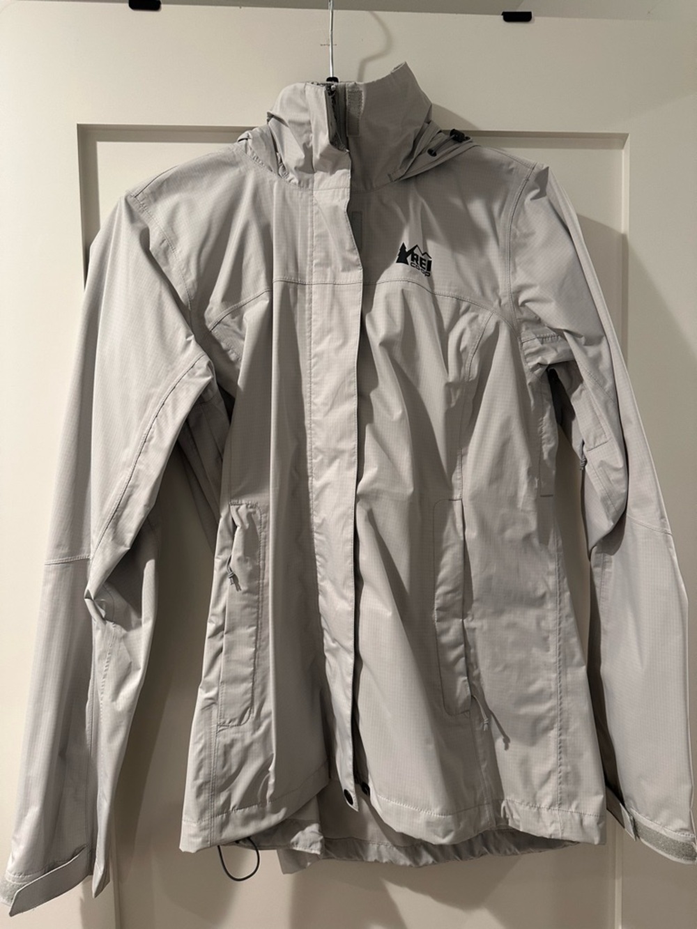 REI gray hooded shell jacket with black logo trim